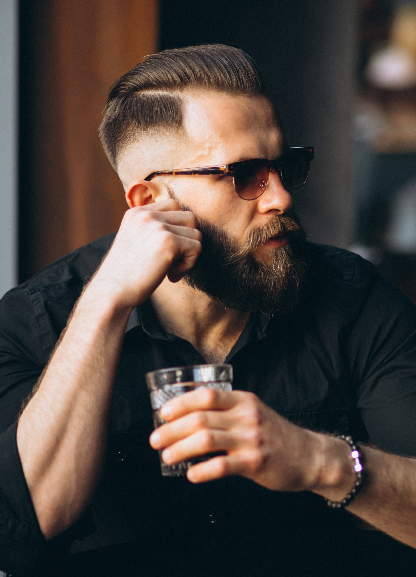 Bearded man drinking in a bar